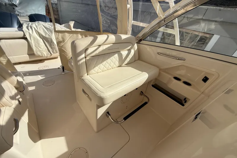 Slide: The Image of 2020 Grady-White Freedom 325 boat interior with beige seating and cup holders. - 18
