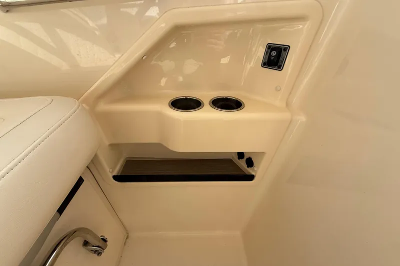 Slide: The Image of Interior detail of a 2020 Grady-White Freedom 325 boat, featuring cup holders and a control panel. - 19