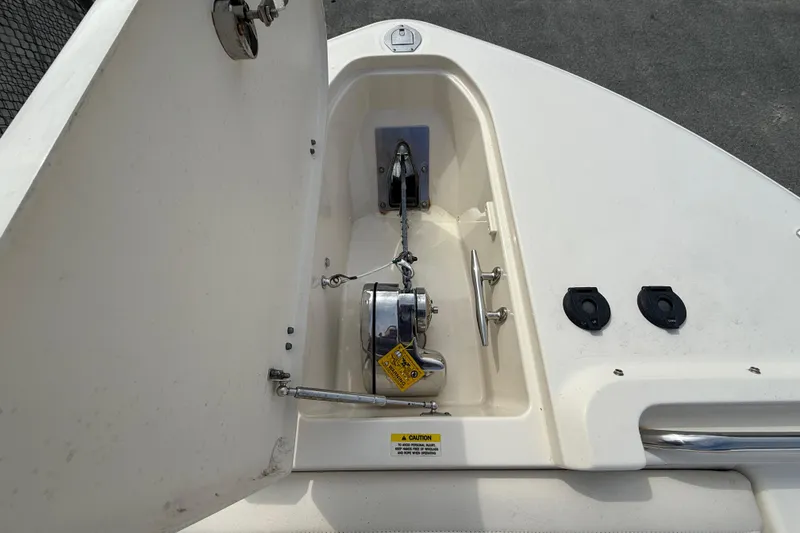 Slide: The Image of Anchor compartment of 2020 Grady-White Freedom 325 boat, featuring winch and cleats. - 25