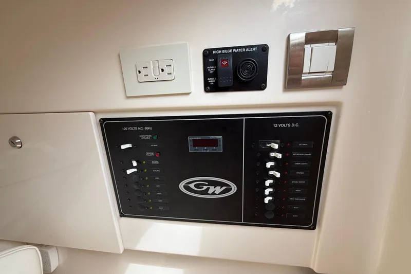 Slide: The Image of Control panel of a 2020 Grady-White Freedom 325 boat, featuring electrical switches and alerts. - 26