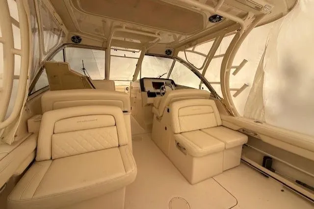 Slide: The Image of 2020 Grady-White Freedom 325 boat interior with luxurious seating and helm station. - 3