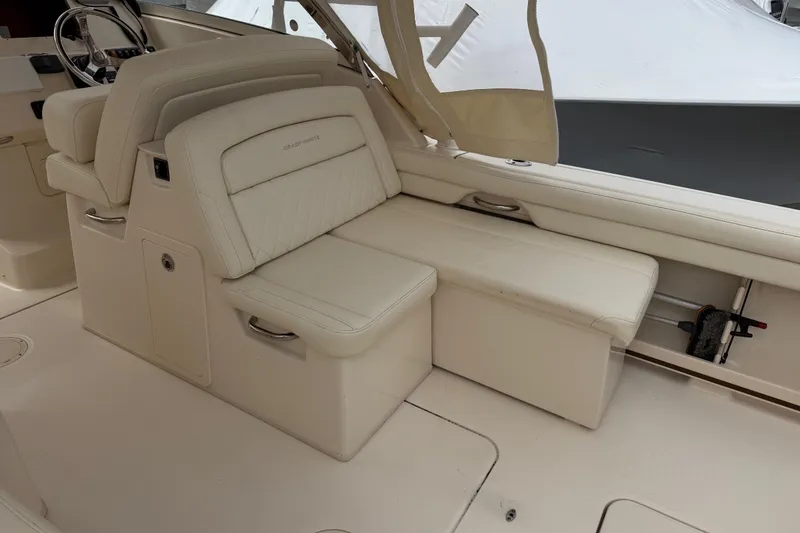 Slide: The Image of 2020 Grady-White Freedom 325 boat interior with beige seating and helm station. - 30