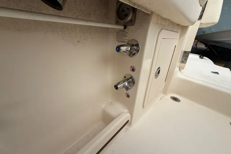 Slide: The Image of 2020 Grady-White Freedom 325 boat interior with utility fixtures and storage compartment. - 37