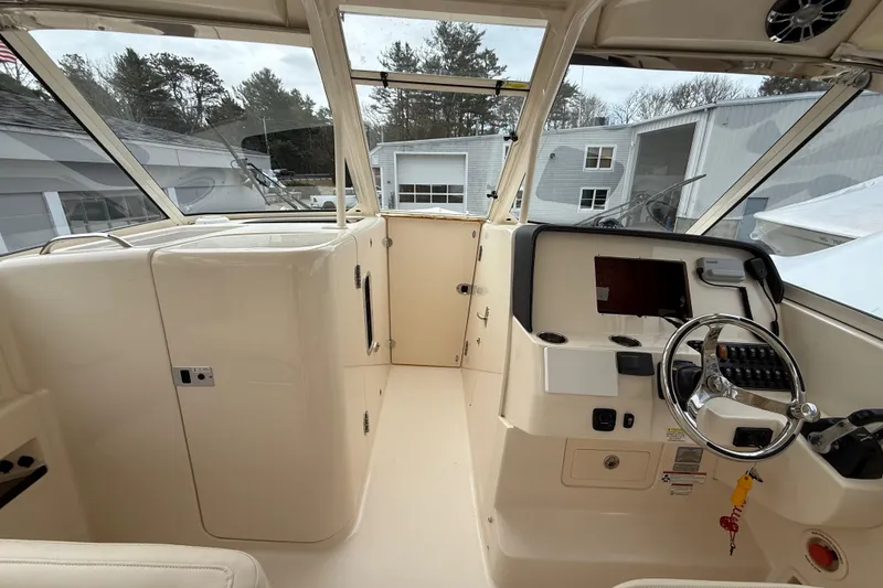 Slide: The Image of 2020 Grady-White Freedom 325 boat interior with steering wheel and control panel. - 41