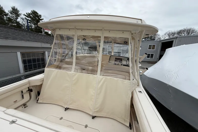 Slide: The Image of 2020 Grady-White Freedom 325 boat with enclosed cockpit, docked near buildings. - 42