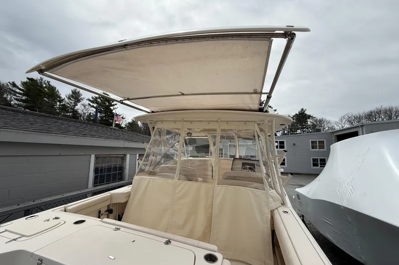 Slide: The Image of 2020 Grady-White Freedom 325 boat with canopy and enclosed cockpit, docked outdoors. - 43