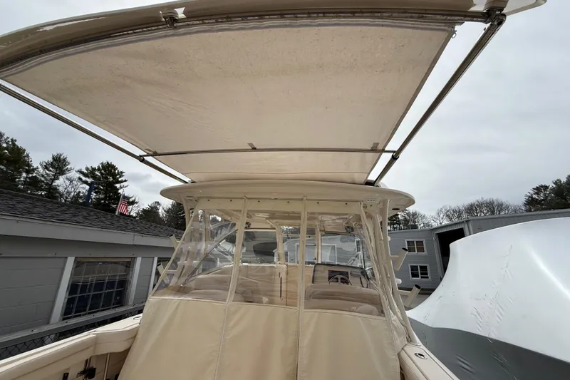 Slide: The Image of 2020 Grady-White Freedom 325 boat with canopy and enclosed cockpit, docked outdoors. - 44