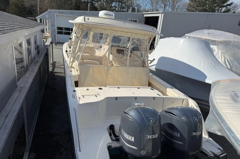 Slide: The Image of 2020 Grady-White Freedom 325 boat with twin Yamaha 300 engines, docked outdoors. - 7