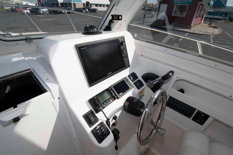 Slide: The Image of 2020 NorthCoast 235 HT boat cockpit with modern navigation equipment and steering wheel. - 10