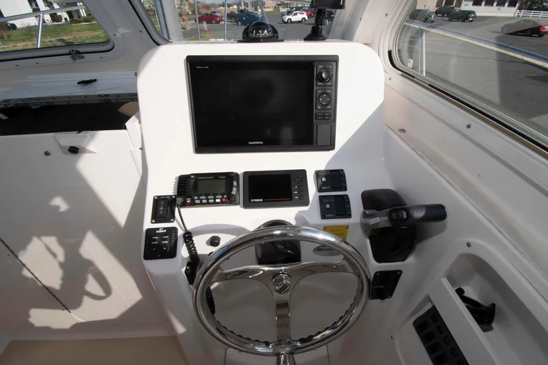 Slide: The Image of 2020 NorthCoast 235 HT boat helm with Garmin display and control panel. - 11