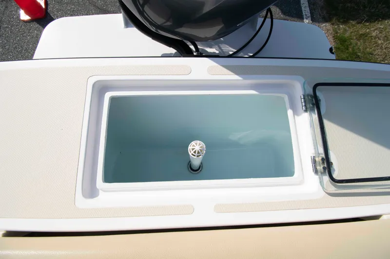 Slide: The Image of Livewell compartment on a 2020 NorthCoast 235 HT boat, featuring a clean, open design. - 13