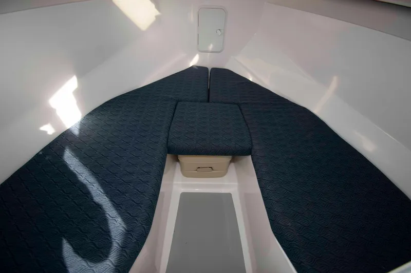 Slide: The Image of Interior cabin of 2020 NorthCoast 235 HT boat with blue cushioned seating. - 14