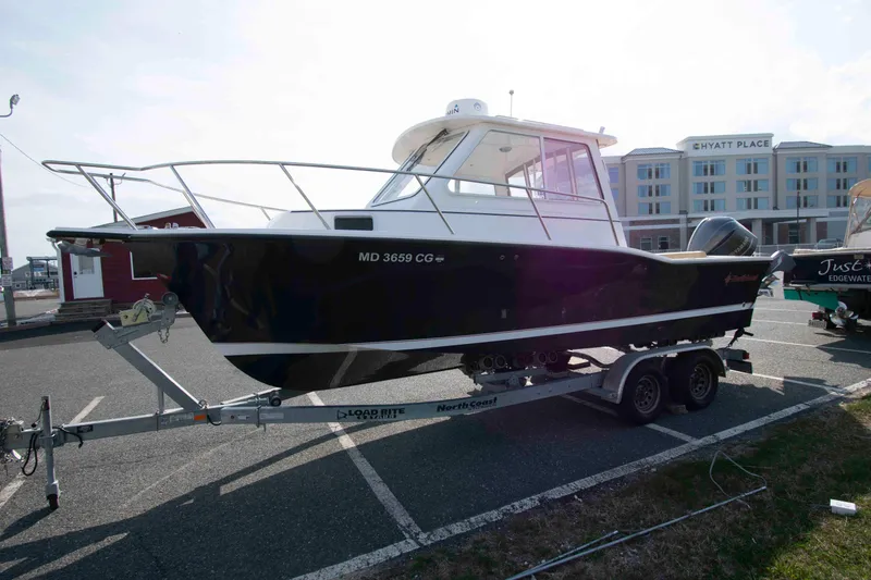 Slide: The Image of 2020 NorthCoast 235 HT boat on trailer in parking lot near hotel. - 2