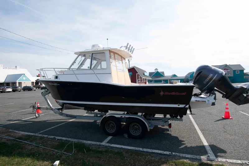 Slide: The Image of 2020 NorthCoast 235 HT boat on trailer in parking lot, near seafood restaurant. - 4