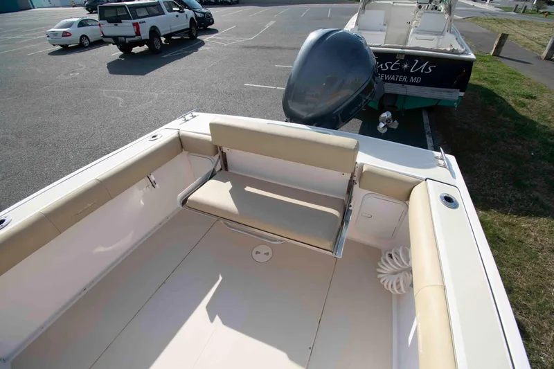 Slide: The Image of 2020 NorthCoast 235 HT boat with seating and outboard motor in parking lot. - 6