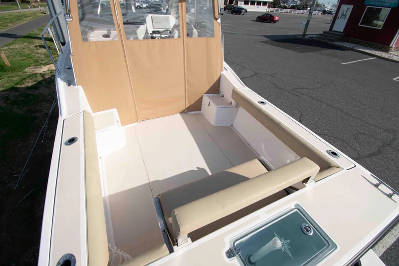 Slide: The Image of 2020 NorthCoast 235 HT boat interior with beige seating and spacious deck area. - 7