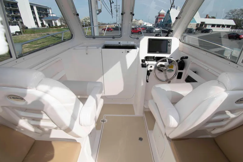 Slide: The Image of Interior of 2020 NorthCoast 235 HT boat with modern helm and seating. - 8