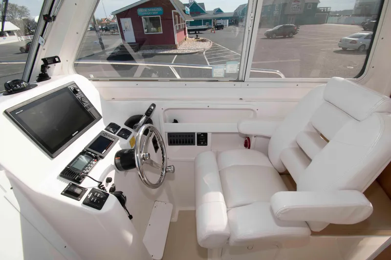 Slide: The Image of Interior of 2020 NorthCoast 235 HT boat with steering wheel and navigation equipment. - 9