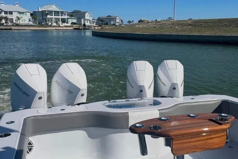 Slide: The Image of Freeman 37VH 2022 boat with four Mercury engines on a scenic waterway. - 14