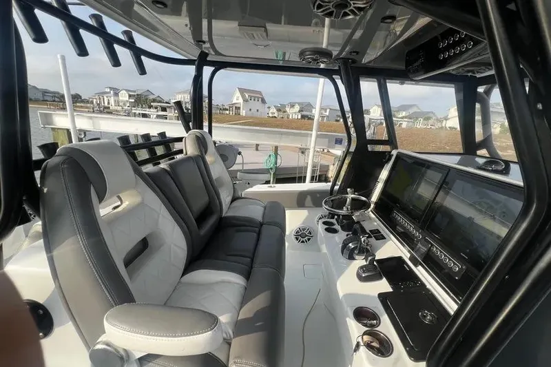 Slide: The Image of Interior of a 2022 Freeman 37VH boat with modern seating and control panel. - 7