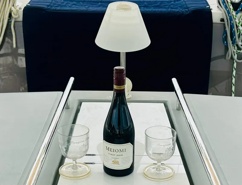 Slide: The Image of Bottle of Meiomi Pinot Noir with glasses on Beneteau Oceanis 45 yacht table. - 16