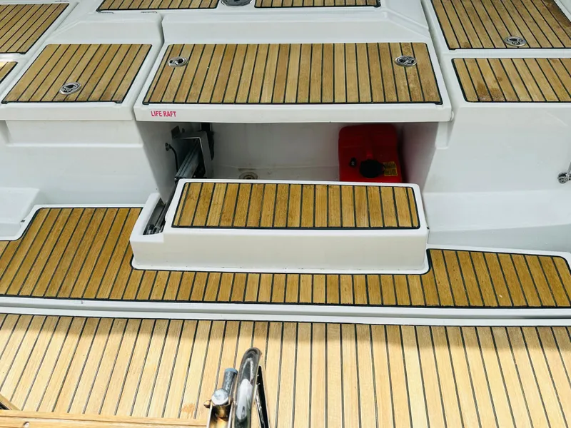 Slide: The Image of Teak deck of 2015 Beneteau Oceanis 45 sailboat with life raft compartment. - 18