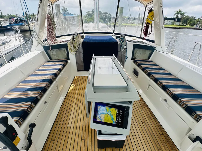 Slide: The Image of 2015 Beneteau Oceanis 45 yacht cockpit with striped seating and navigation equipment. - 30