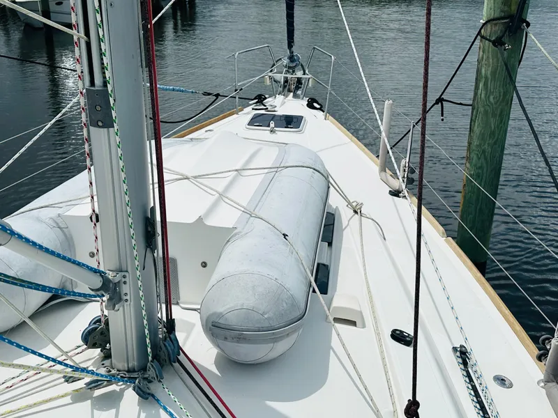 Slide: The Image of 2015 Beneteau Oceanis 45 sailboat deck with dinghy and rigging. - 37