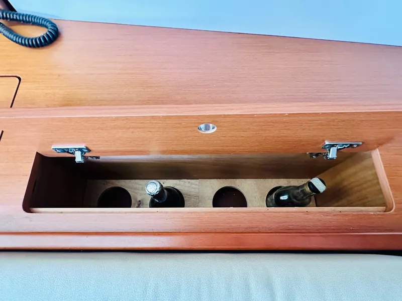 Slide: The Image of Wooden storage compartment with bottles on a 2015 Beneteau Oceanis 45 yacht. - 42