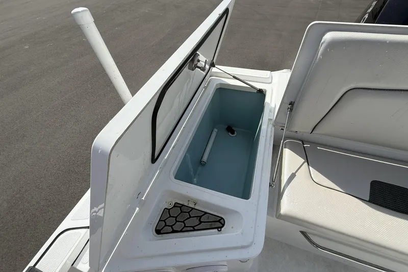 Slide: The Image of Open storage compartment on a 2019 Wellcraft 221 Bay boat, showcasing interior space. - 10