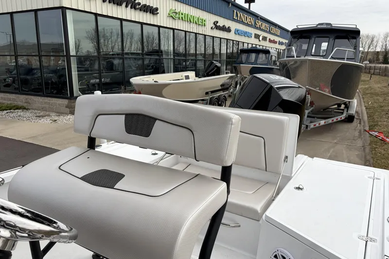 Slide: The Image of 2019 Wellcraft 221 Bay boat displayed at dealership with other boats. - 11
