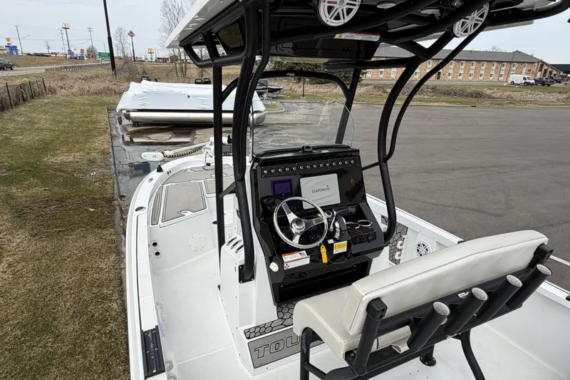 Slide: The Image of 2019 Wellcraft 221 Bay boat with Garmin navigation, parked on grass near a road. - 12