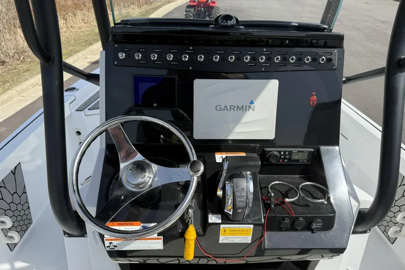 Slide: The Image of 2019 Wellcraft 221 Bay boat dashboard with Garmin navigation system and steering wheel. - 13