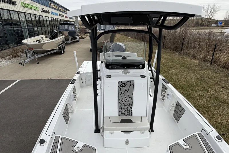 Slide: The Image of 2019 Wellcraft 221 Bay boat interior view at dealership, showcasing seating and console. - 15