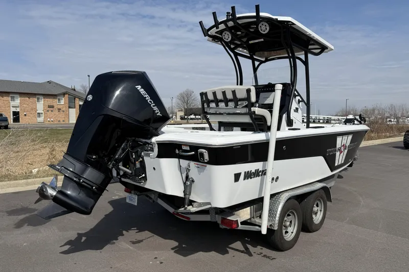 Slide: The Image of 2019 Wellcraft 221 Bay boat with Mercury outboard engine on trailer. - 4