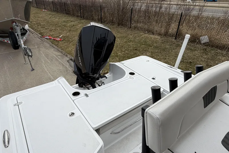 Slide: The Image of 2019 Wellcraft 221 Bay boat with Mercury outboard motor, parked on a trailer. - 6