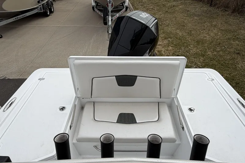 Slide: The Image of 2019 Wellcraft 221 Bay boat with open storage compartment and visible outboard motor. - 7