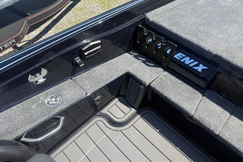 Slide: The Image of Interior of 2026 Phoenix 721 ZXL boat with gray carpet and storage compartments. - 14