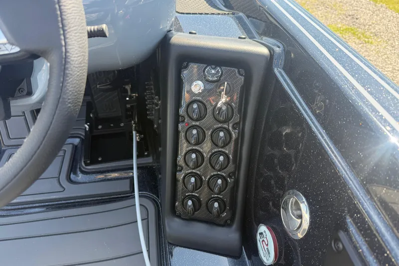 Slide: The Image of Control panel of 2026 Phoenix 721 ZXL boat with switches and steering wheel. - 15