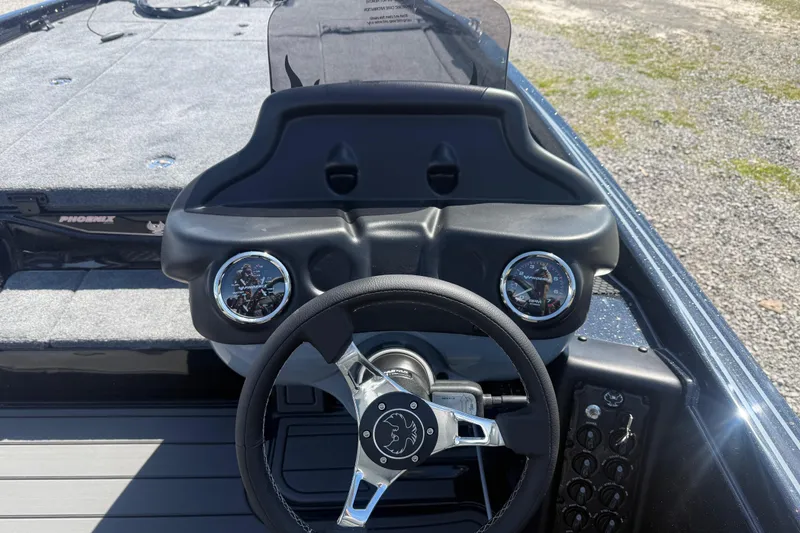 Slide: The Image of 2026 Phoenix 721 ZXL boat dashboard with steering wheel and gauges. - 16