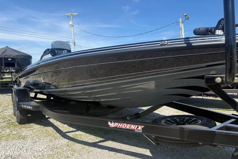 Slide: The Image of 2026 Phoenix 721 ZXL boat on trailer under clear blue sky. - 5