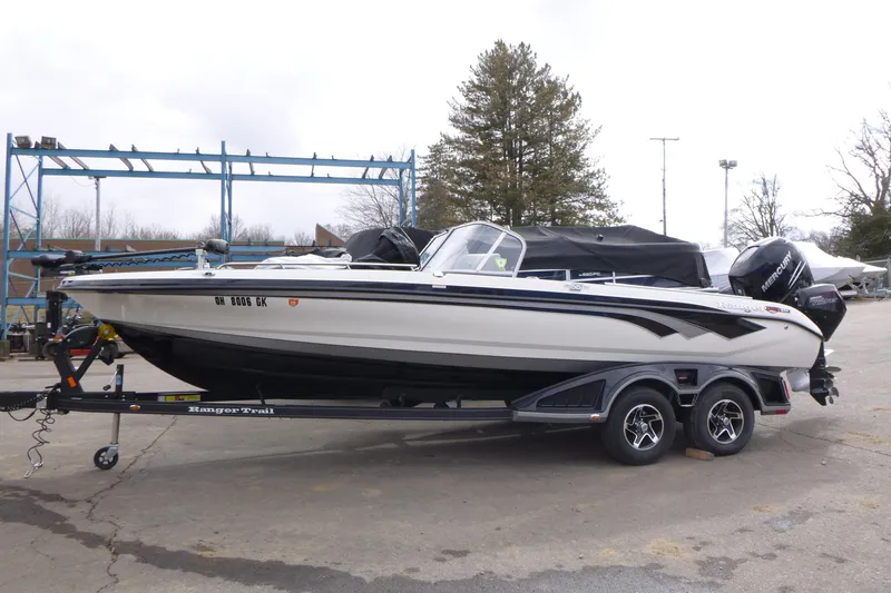 The Image of 2023 Ranger 622FS Pro boat on trailer, parked outdoors, side view. - 1