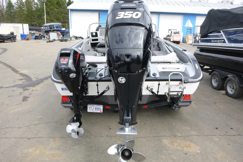 Slide: The Image of 2023 Ranger 622FS Pro boat with dual outboard motors in a marina setting. - 4