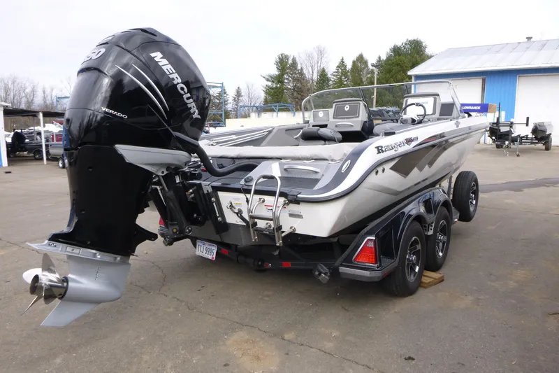 Slide: The Image of 2023 Ranger 622FS Pro boat with Mercury engine on trailer, parked outdoors. - 5