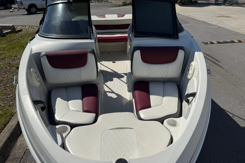 Slide: The Image of 2016 Tahoe 400 TS boat interior with white and maroon seating, parked outdoors. - 4