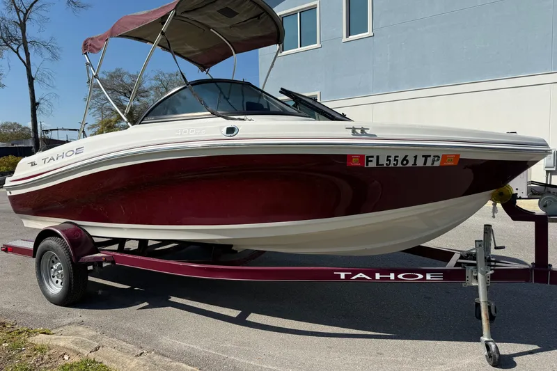 Slide: The Image of 2016 Tahoe 400 TS boat on trailer, parked outdoors with canopy. - 5