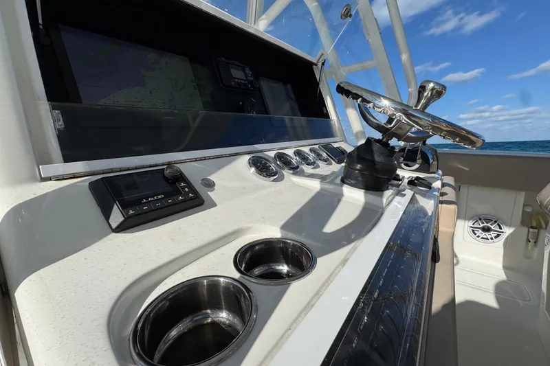 Slide: The Image of 2021 SeaVee Boats 370Z helm with steering wheel, controls, and ocean view. - 11