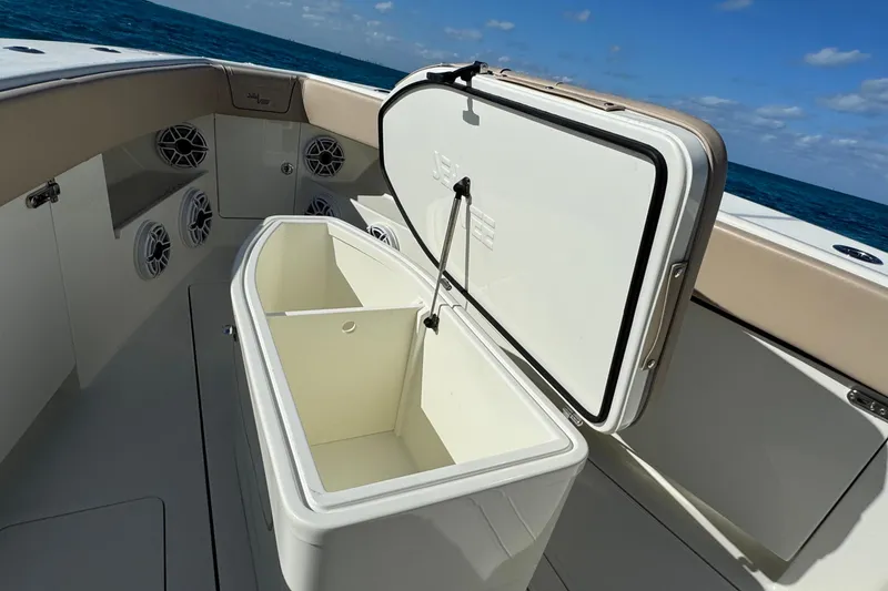 Slide: The Image of Open storage compartment on 2021 SeaVee Boats 370Z, with ocean view in background. - 15