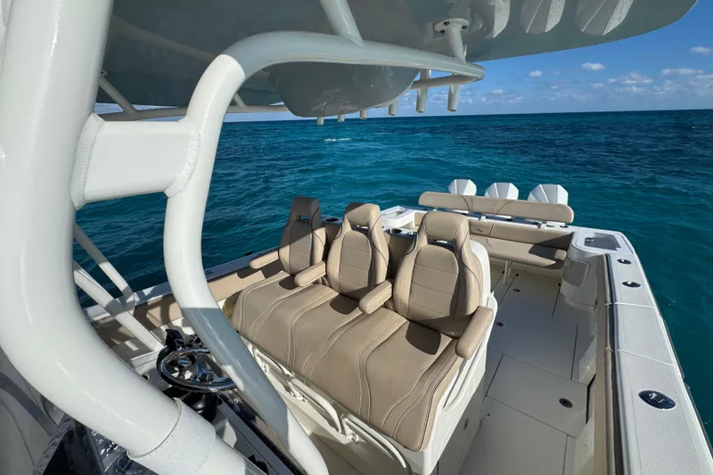 Slide: The Image of 2021 SeaVee Boats 370Z interior with beige seating, ocean backdrop. - 16