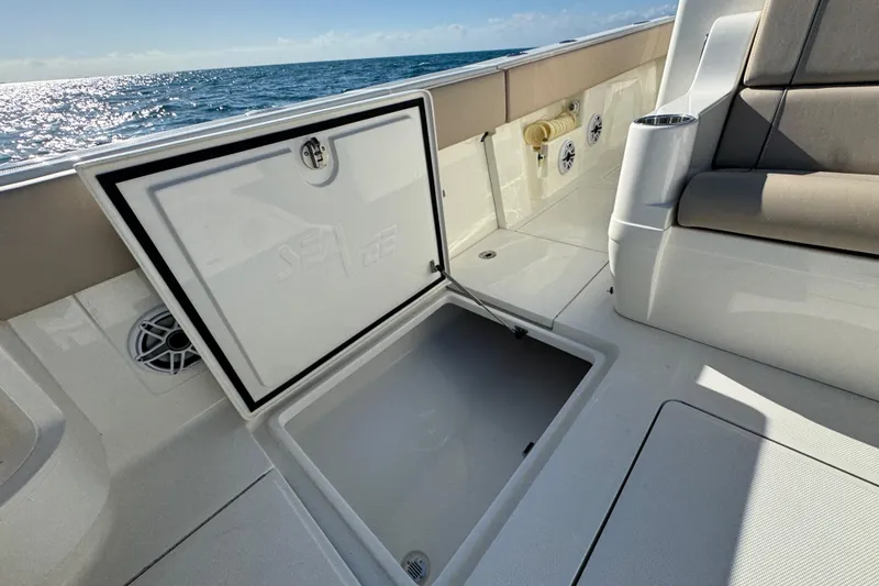 Slide: The Image of 2021 SeaVee Boats 370Z open storage compartment on deck, ocean view in background. - 19